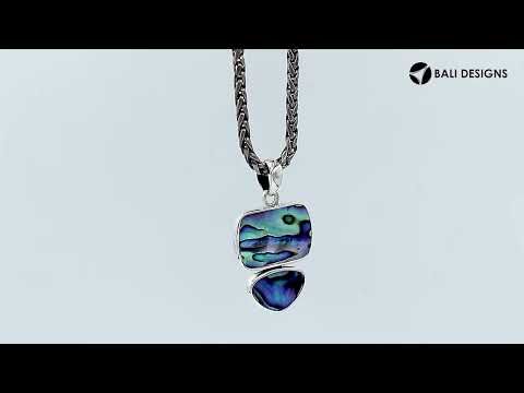 Sterling silver pendant featuring double Turquoise Shell stones with a polished surface and detailed Balinese craftsmanship.