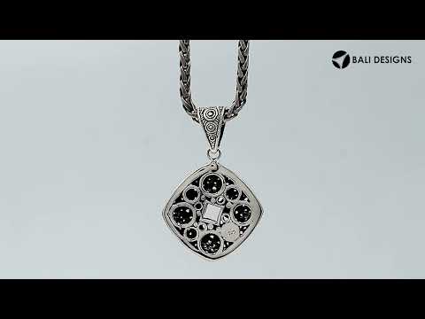 Sterling silver diamond-shaped pendant featuring circular dot engravings, geometric Balinese detailing, and polished oxidized finish.