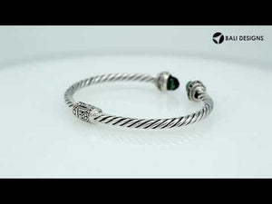 Sterling silver wholesale bangle with twisted rope design, featuring Green Quartz and Cubic Zirconia end caps with Balinese motifs.