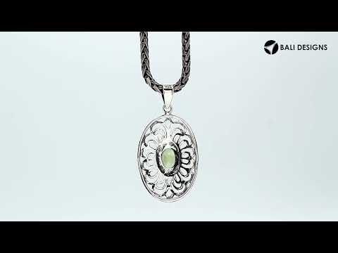 Handcrafted sterling silver pendant with Peridot Quartz in an oval Balinese filigree frame and polished silver finish.
