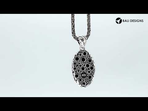 Wholesale sterling silver oval pendant with abstract carved black pattern.