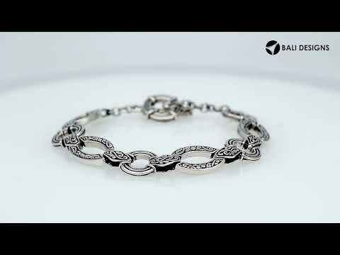 Wholesale sterling silver Bali link bracelet with alternating engraved infinity links and circular connectors, finished with a secure toggle lock for premium jewelry inventory.