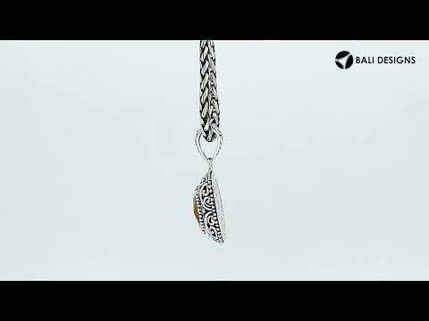 Sterling silver cushion pendant featuring a faceted Citrine Quartz centerpiece accented with intricate Balinese scroll carvings and a polished decorative frame.