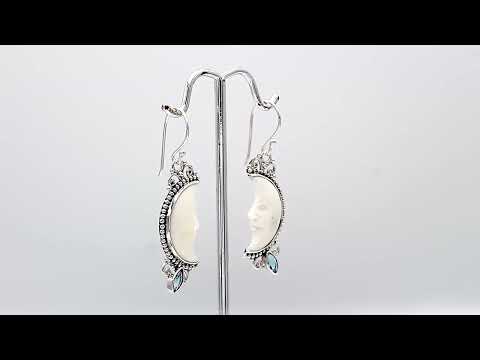 Sterling silver lunar bone face earrings with blue topaz quartz accent and earwire lock
