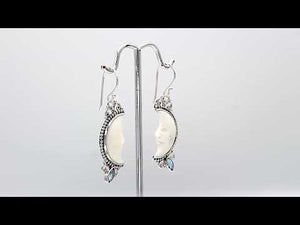 Sterling silver lunar bone face earrings with blue topaz quartz accent and earwire lock
