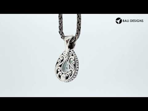 Sterling silver pendant featuring a teardrop Mystic Quartz set in a detailed carved Balinese frame with a glossy polished finish.