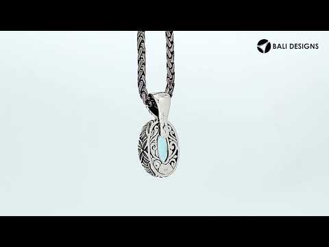 Sterling silver oval-shaped Blue Topaz Quartz pendant with floral detailing and enhancer bail, polished for brilliance and ideal for wholesale jewelry collections and catalogs.