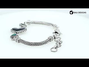 Wholesale sterling silver bracelet featuring Turquoise Shell heart motifs, crafted with intricate Balinese ornamental detailing and secured with a lobster lock for premium artisan-style jewelry collections.