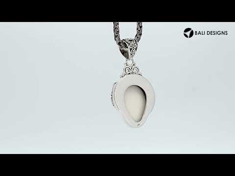 Wholesale sterling silver pendant with hand-carved bone face and peridot gemstones, Bali artisan jewelry in bulk.