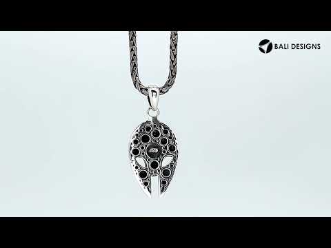 Sterling silver mask-shaped pendant featuring engraved tribal detailing, polished borders, and textured elements suitable for classic wholesale jewelry collections and retail displays