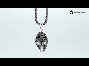 Sterling silver mask-shaped pendant featuring engraved tribal detailing, polished borders, and textured elements suitable for classic wholesale jewelry collections and retail displays