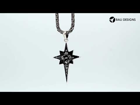 A handcrafted sterling silver compass star pendant featuring ornate Balinese filigree detailing and a high-polished finish.