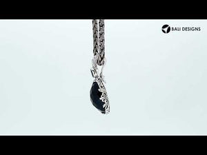 Sterling silver pendant featuring Ruby Quartz with Blue Topaz Quartz accent set in a carved Balinese frame with a polished glossy finish.