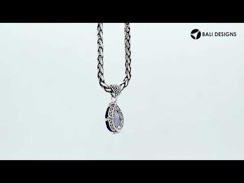 Sterling silver pear-shaped pendant featuring a faceted Amethyst Quartz centerpiece with polished prong-setting and traditional Balinese carved ornamental accents.