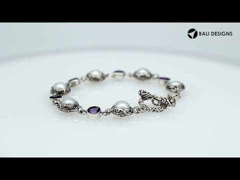 Wholesale sterling silver bracelet featuring alternating Mabe Pearl and Amethyst quartz gemstones in decorative round links with oxidized detailing and a secure toggle lock closure.