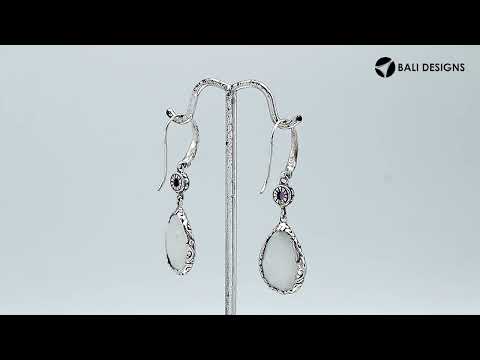 Wholesale sterling silver earrings combining a faceted rainbow moonstone teardrop with an amethyst quartz accent, framed by ornate Balinese detailing for consistent artisan quality and strong catalog-ready wholesale presentation.