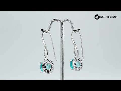 Wholesale Sterling Silver Blue Topaz Quartz Round Infinity Earrings With Detailed Balinese-Style Metalwork.
