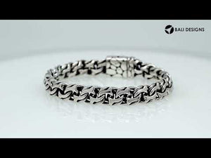 A wholesale sterling silver heavy woven bracelet featuring a textured push clasp, polished and oxidized detailing, and rugged craftsmanship designed for premium bulk jewelry collections.