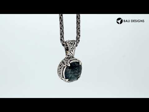 Sterling silver cushion pendant featuring Labradorite set in a carved Balinese frame with a polished high-gloss finish.