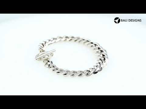 Sterling Silver curb chain bracelet featuring a smooth toggle lock and polished high-gloss surface, crafted to provide durable structure for premium wholesale presentation.