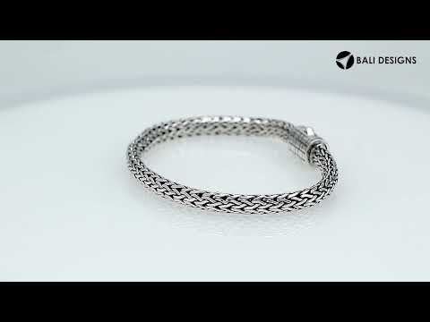 A wholesale sterling silver compact woven bracelet with an etched push clasp, featuring polished and oxidized detailing crafted for high-quality bulk jewelry collections.