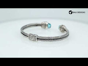 Sterling silver wholesale bangle with twisted rope design, accented by Blue Topaz Quartz and Balinese handcrafted motifs.