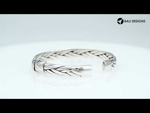 A wholesale sterling silver small woven bangle featuring polished Balinese textures, smooth finishing, and a secure hinge lock perfect for lightweight premium jewelry collections.