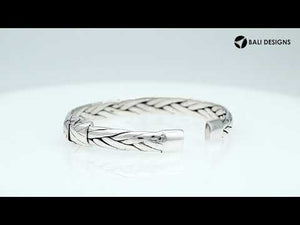 A wholesale sterling silver small woven bangle featuring polished Balinese textures, smooth finishing, and a secure hinge lock perfect for lightweight premium jewelry collections.