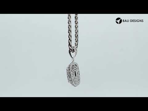 Sterling silver cushion pendant featuring a faceted Blue Topaz Quartz centerpiece accented with intricate Balinese scroll carvings and a polished decorative frame.