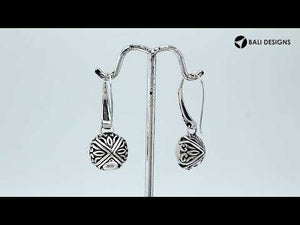 Wholesale sterling silver earrings featuring luminous Mabe pearls set in ornate Balinese-style silver detailing, crafted to deliver consistent artisan quality and an elegant catalog-ready presentation for wholesale jewelry buyers.