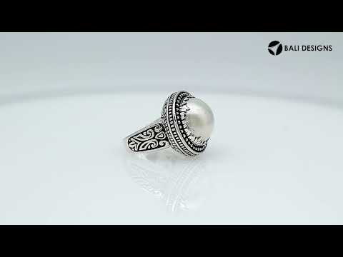Sterling silver handcrafted Bali ring with Mother of Pearl cabochon and beaded halo design.