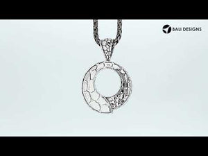 Sterling silver round pendant with pebble-textured design and open circle center, handcrafted Bali jewelry available for wholesale purchase.