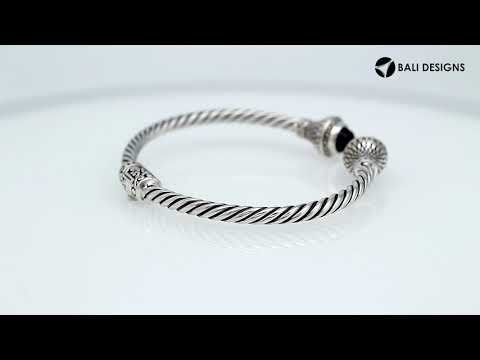 Sterling silver twisted cuff bracelet with Black Onyx caps and detailed oxidized Balinese motifs.