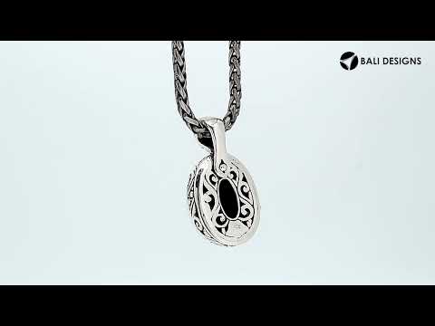 Sterling silver pendant featuring a faceted Blue Sapphire Quartz set in a carved Balinese frame with a polished glossy finish.