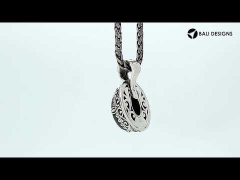 Sterling silver oval pendant featuring a vibrant Amethyst Quartz centerpiece surrounded by intricate Balinese scroll carvings and a smoothly polished artistic frame design.