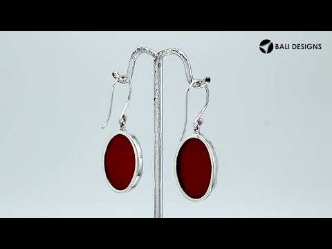 Wholesale sterling silver earrings featuring oval red coral drops with a polished wave-motif overlay, offering reliable craftsmanship and elegant presentation suitable for bulk jewelry orders.