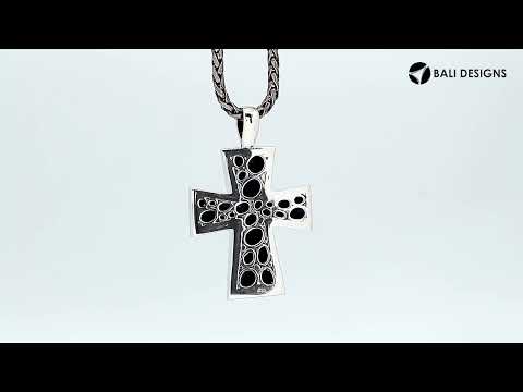 Sterling silver cross pendant featuring polished pebble texture and oxidized Balinese handcrafted detailing.