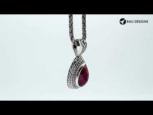 Sterling silver teardrop pendant featuring faceted Ruby Quartz set in a carved Balinese frame with a polished glossy finish.