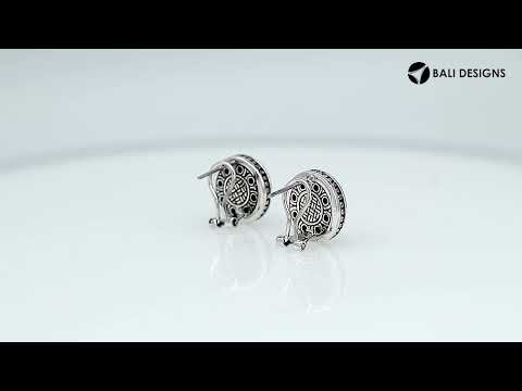 Wholesale sterling silver round patterned earrings with textured metal detailing and omega clip closure.