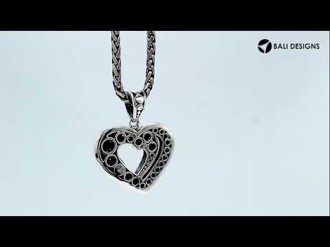 Sterling silver heart-shaped pendant featuring layered open-heart design, dotted Balinese pattern, and oxidized polished finish.