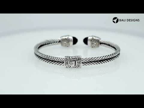 Sterling silver wholesale bangle with twisted rope design, finished with Black Onyx end caps and Balinese detailing.