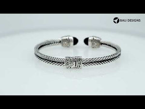 Sterling silver wholesale bangle with twisted rope design, finished with Black Onyx end caps and Balinese detailing.