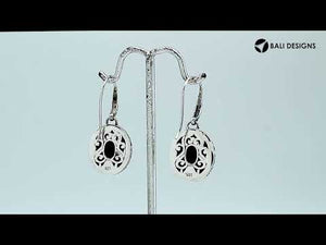 Wholesale sterling silver earrings featuring a faceted oval Sapphire stone framed with intricate carved detailing and earwire lock, offering deep blue brilliance and artisan craftsmanship ideal for premium wholesale jewelry catalogs.