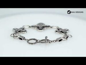 Sterling Silver bracelet featuring multiple cross-shaped links with detailed scroll patterns, polished edges, and a secure toggle lock for wholesale jewelry collections.