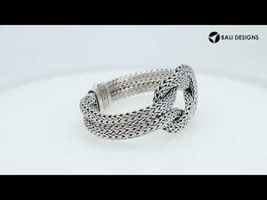Wholesale sterling silver multi-strand woven knot bangle featuring a thick Balinese-style chain weave and a secure push clasp for premium artisan jewelry displays.
