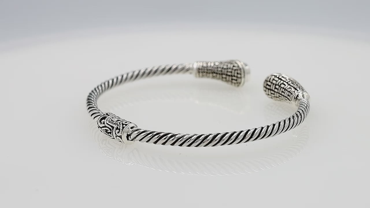 Silver twisted cable bangle in 925 sterling silver with Blue Topaz Quartz ends and Balinese engraving.