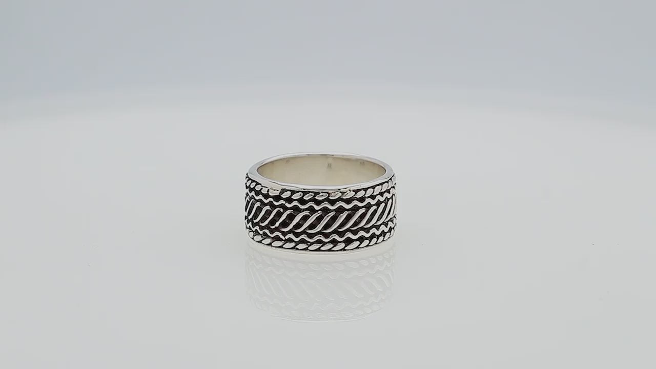 Wholesale sterling silver wide band ring with diagonal braided Bali-inspired design and oxidized details, handcrafted unisex artisan jewelry in bulk for retailers and resellers.