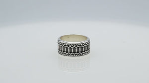 Wholesale sterling silver wide band ring with oxidized Bali-inspired carvings, handcrafted unisex artisan jewelry in bulk for retailers and resellers.