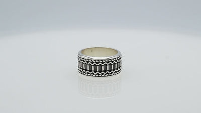 Wholesale sterling silver wide band ring with oxidized Bali-inspired carvings, handcrafted unisex artisan jewelry in bulk for retailers and resellers.