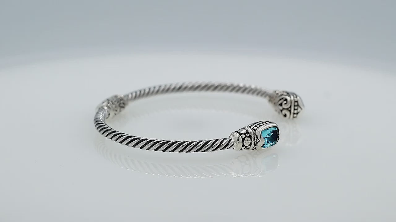Silver twisted cable bangle in 925 sterling silver with Garnet Quartz ends and Balinese engraving.